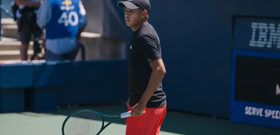 Player preparing to serve during tennis match