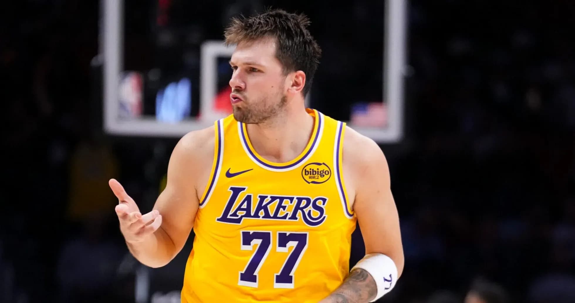Player celebrating during a game in Lakers jersey
