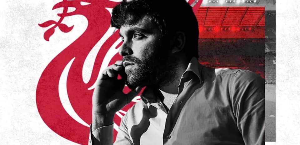 Person on phone with Liverpool logo in background