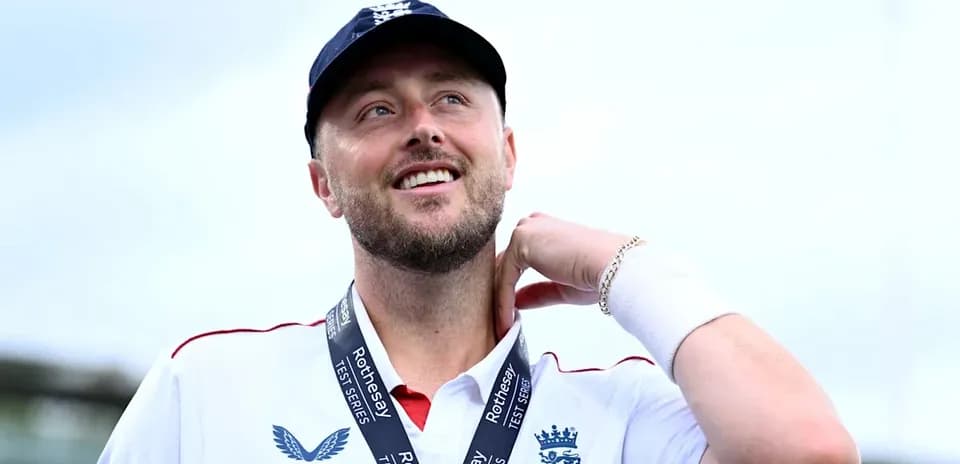 Cricketer wearing England kit with medal around neck