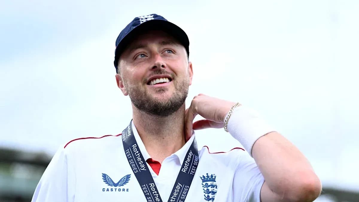 Cricketer wearing England kit with medal around neck