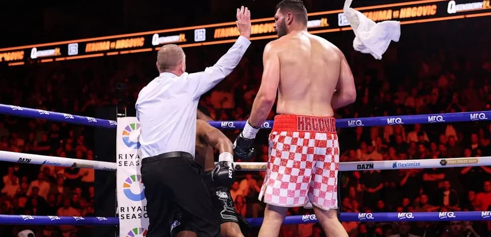 Referee stopping the boxing match with towel thrown