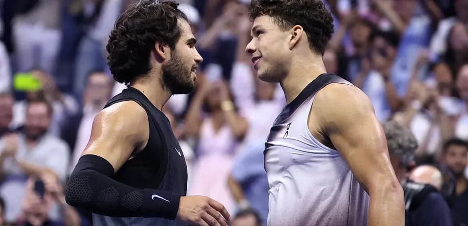 Two tennis players shaking hands after match