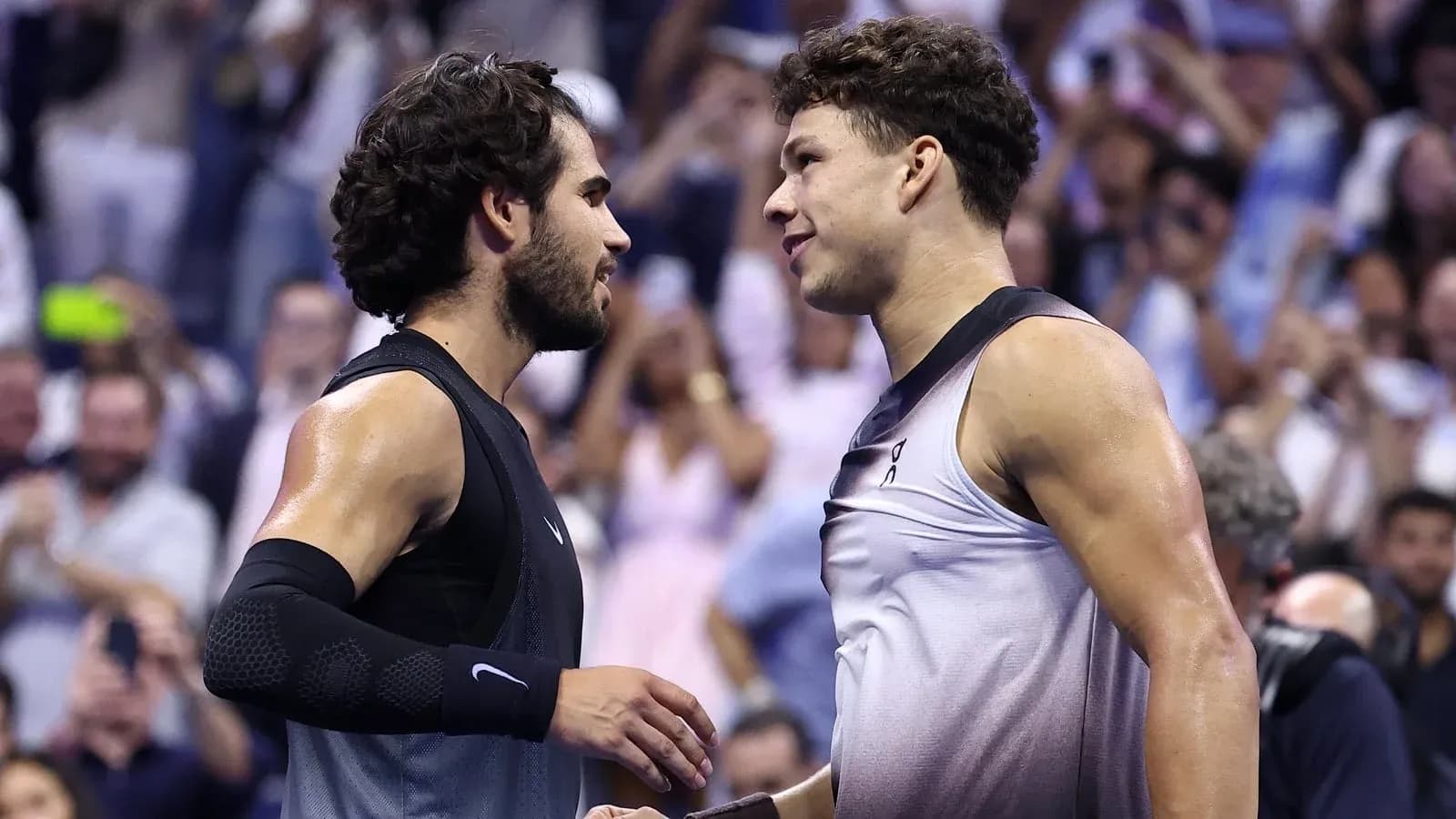 Two tennis players shaking hands after match