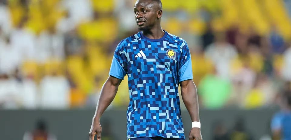 Player in blue patterned jersey during match warm-up