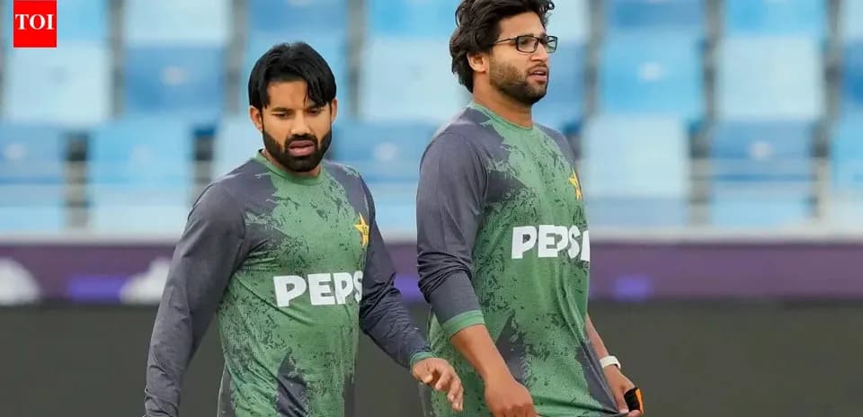 Two Pakistani cricketers walking on the field