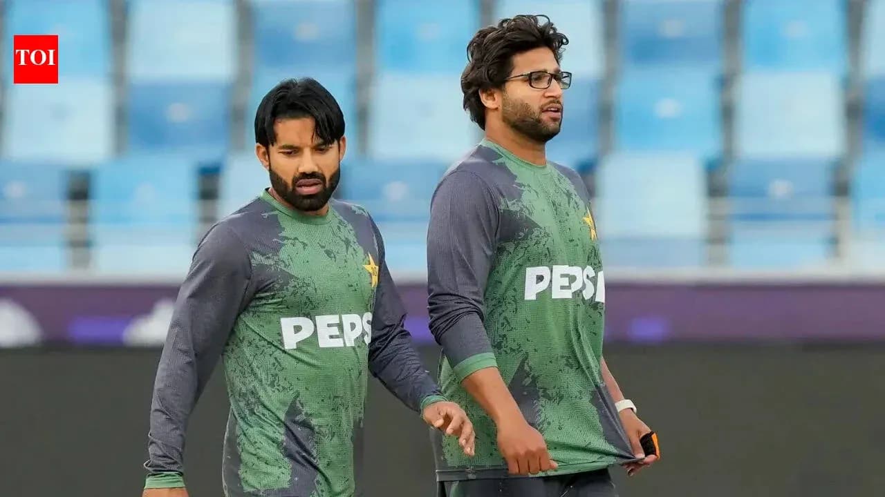 Two Pakistani cricketers walking on the field
