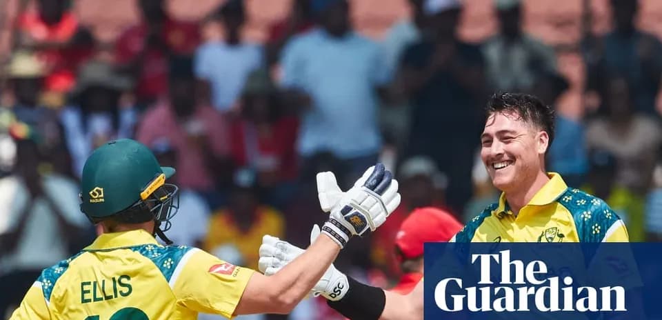 Two Australian cricketers celebrating a wicket on field