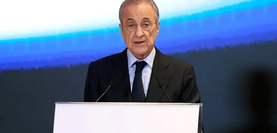 Speaker addressing audience at podium with microphones