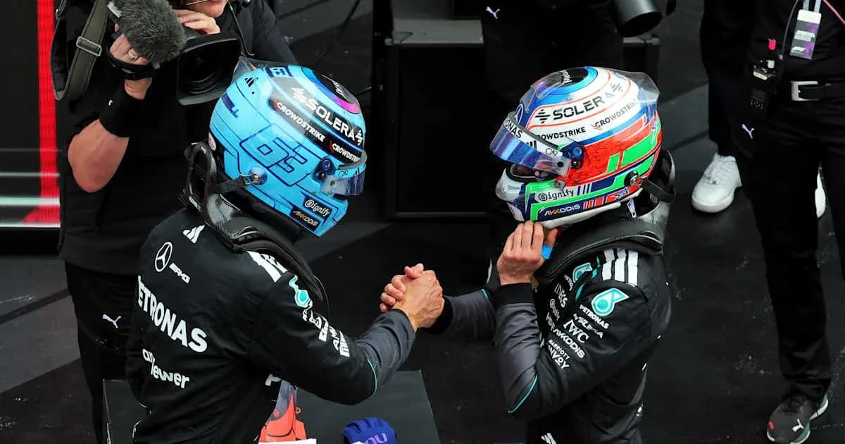 Two Formula 1 drivers shaking hands on podium