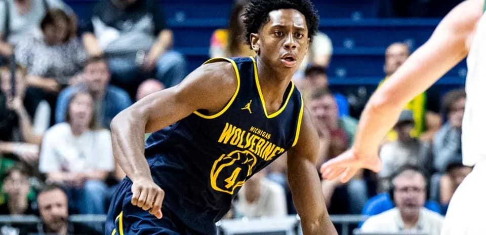 Player in Michigan Wolverines jersey on court