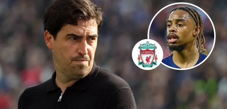 Coach observing match with Liverpool logo and player