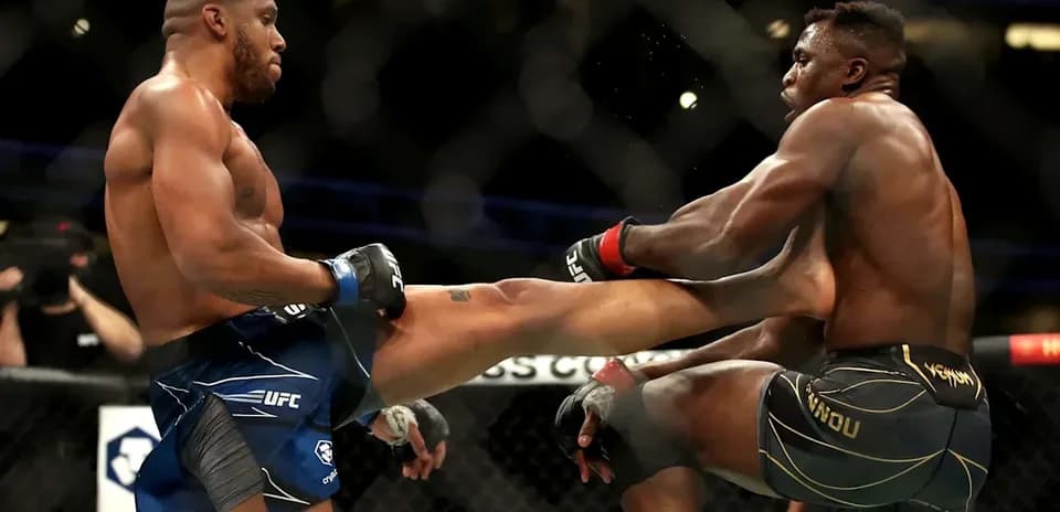 Two fighters exchanging kicks inside the octagon