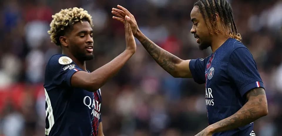 Two PSG players high-fiving on the pitch