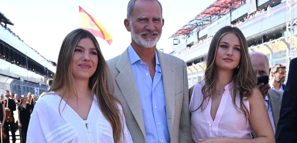 Three people posing at a motorsport event