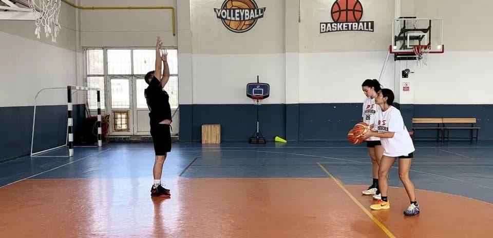 Player practicing a shot with two teammates observing