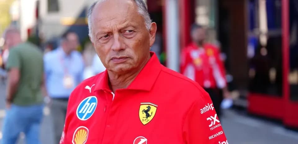 Team member in red Ferrari uniform at event
