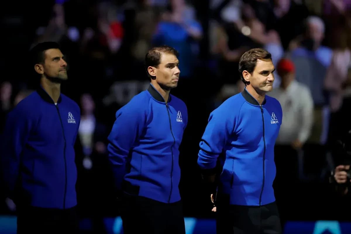 Three tennis players standing together in blue jackets