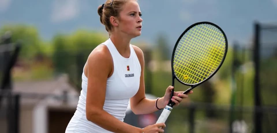Female tennis player preparing to serve on court