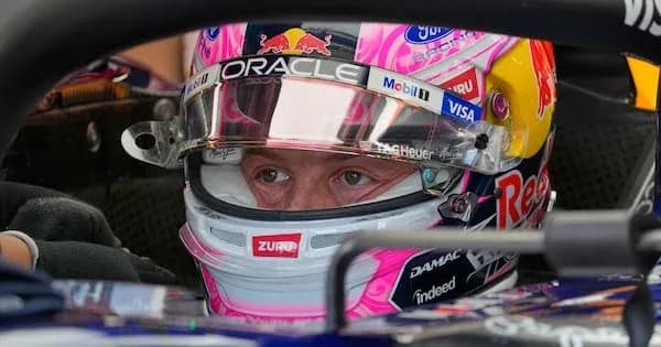Driver in helmet seated in Formula 1 car