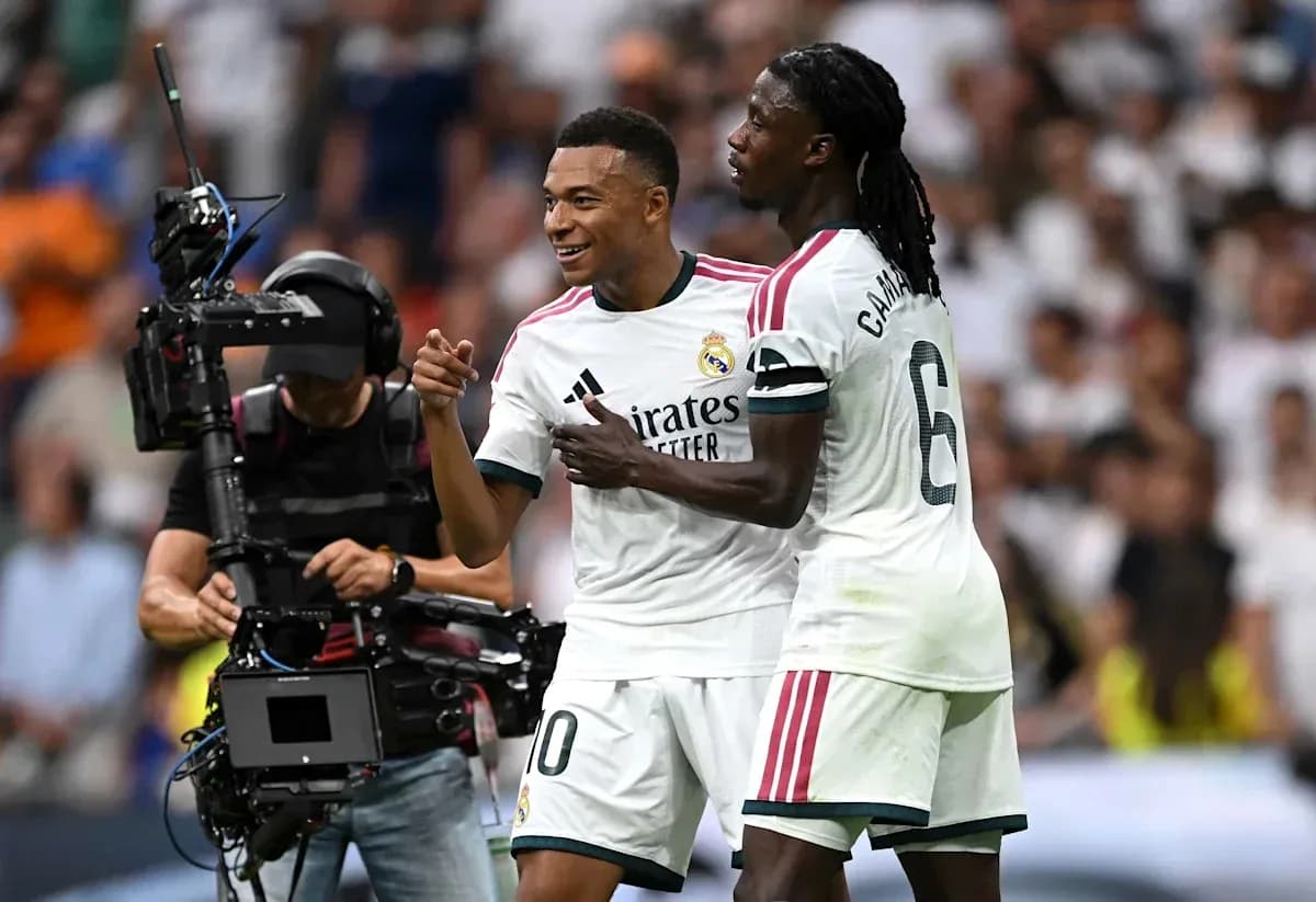 Players celebrating during a match with camera crew