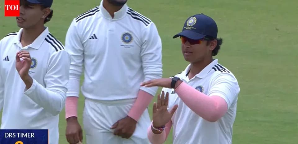 Cricket players discussing strategy on field