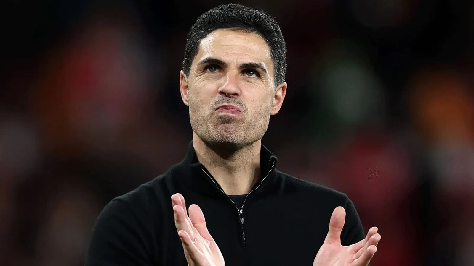 Coach clapping and acknowledging fans after match