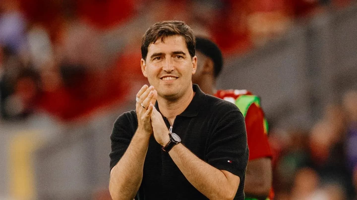 Coach applauding during a match on the sidelines