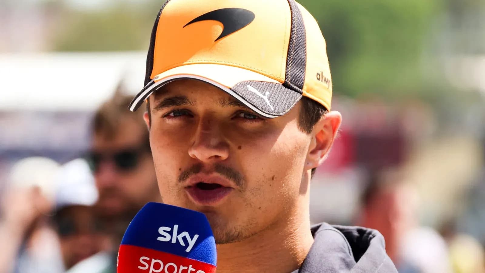 Driver speaking into microphone during event interview