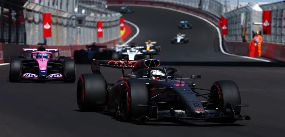 Formula 1 cars racing on a winding circuit