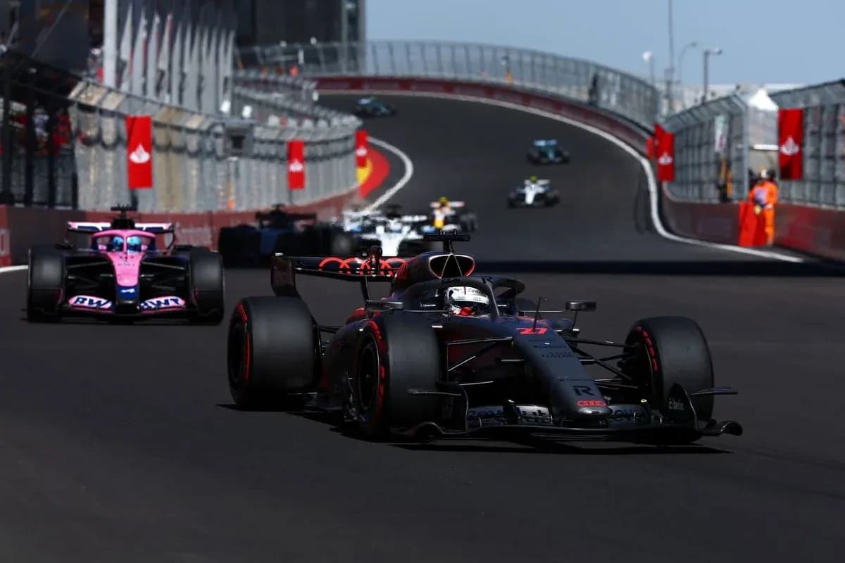 Formula 1 cars racing on a winding circuit