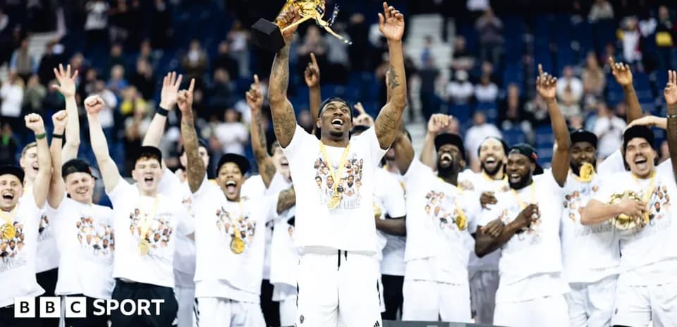 Team celebrating with trophy after championship victory