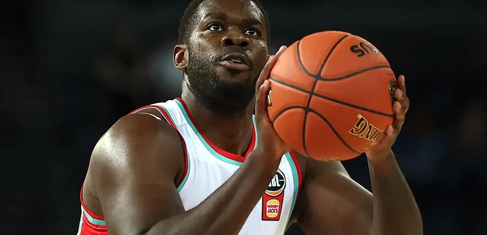 Player preparing to shoot basketball during game