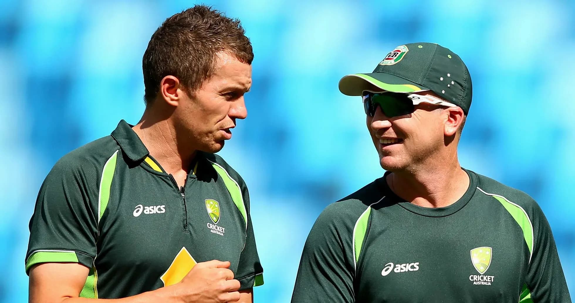 Two Australian cricket players talking during practice