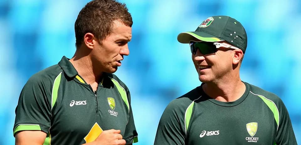 Two Australian cricket players talking during practice