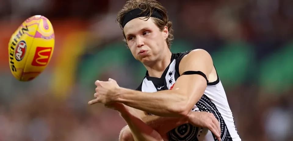 Player kicking an AFL ball during match
