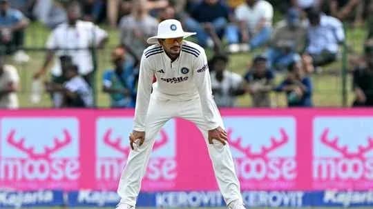 Cricketer in white uniform fielding during match