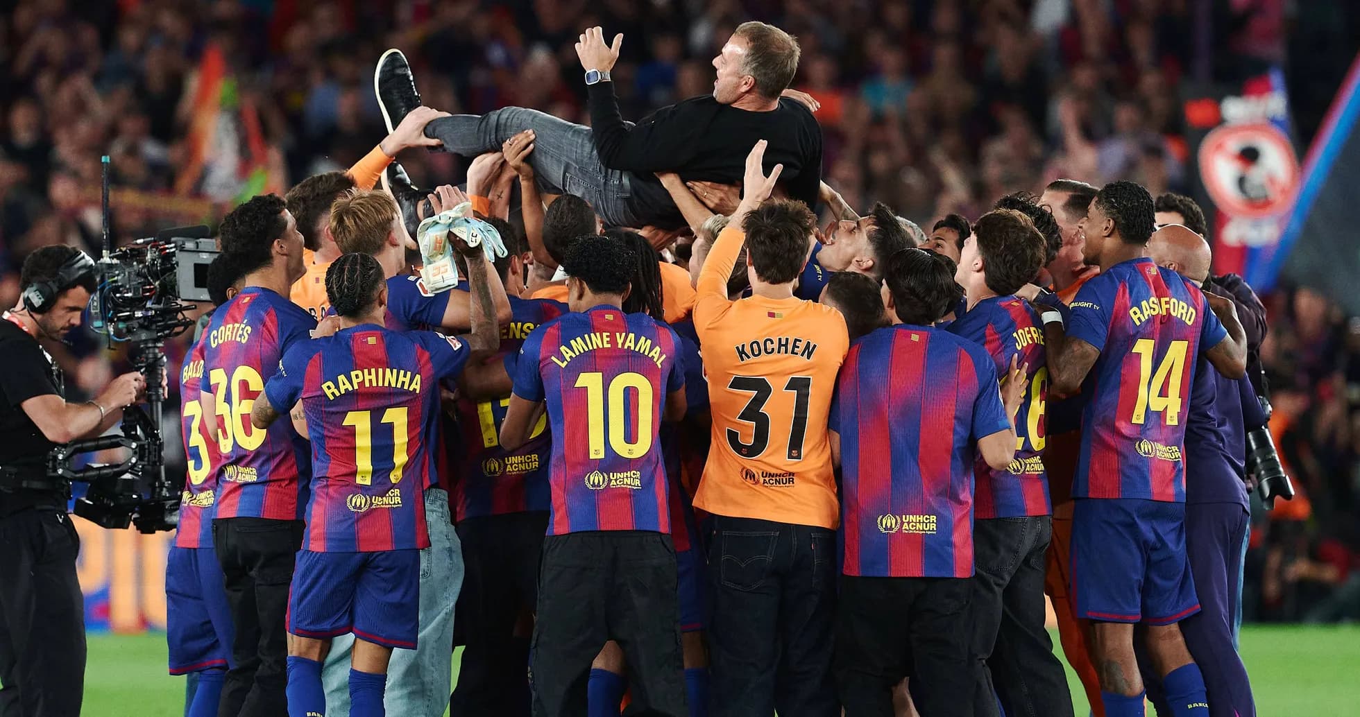 Barcelona players celebrating with their coach after victory
