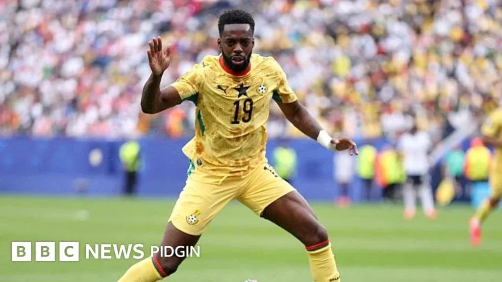 Ghana player in yellow jersey during match action