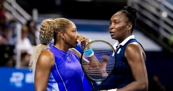 Two female tennis players talking during match