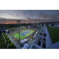 Crowd watching a tennis match at sunset