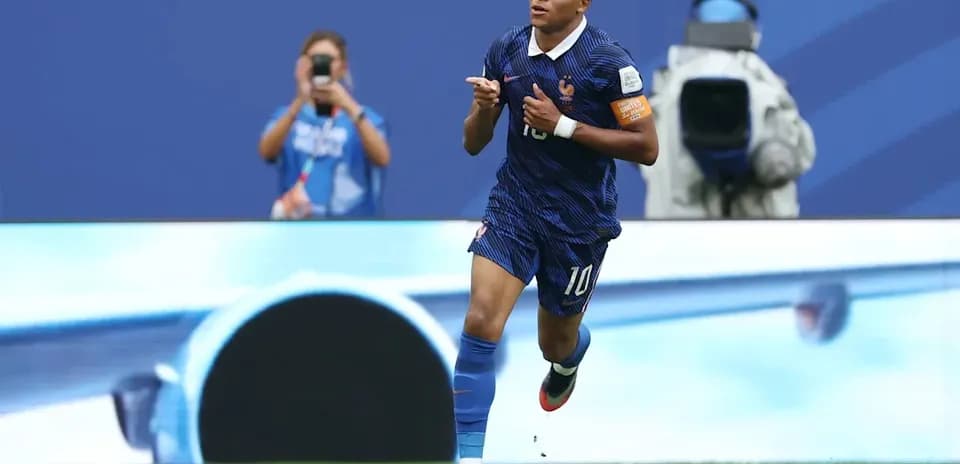 Player celebrating goal during match in blue uniform