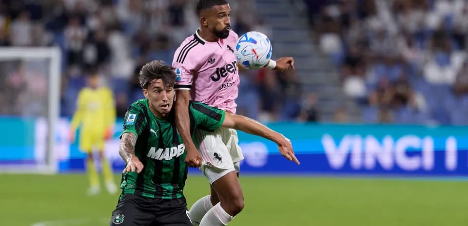 Player from Juventus in pink jersey contests ball