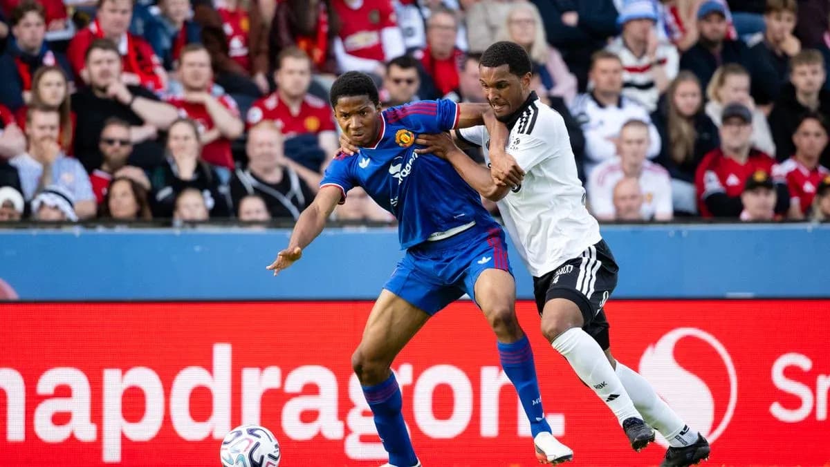 Players competing for the ball during football match