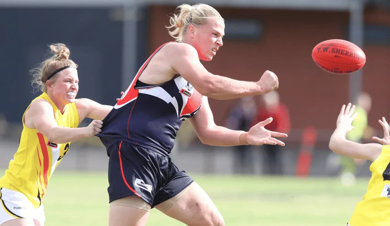 Player passing the ball while being tackled
