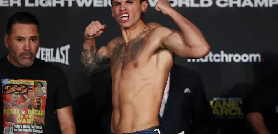 Boxer posing during weigh-in event with opponent