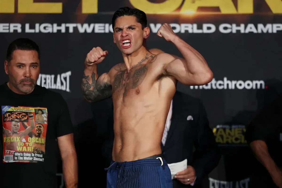 Boxer posing during weigh-in event with opponent