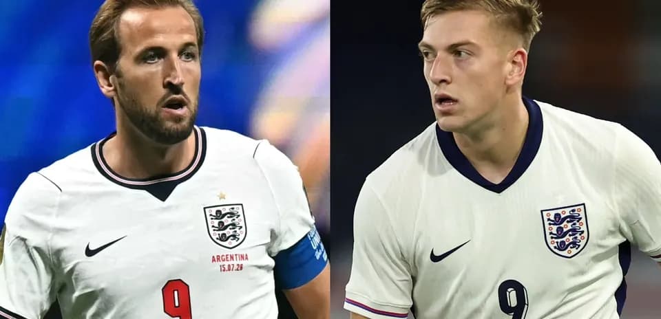 Two England players in white jerseys during match