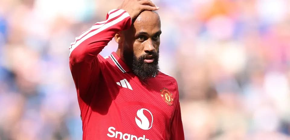 Player in red jersey looking concerned during match