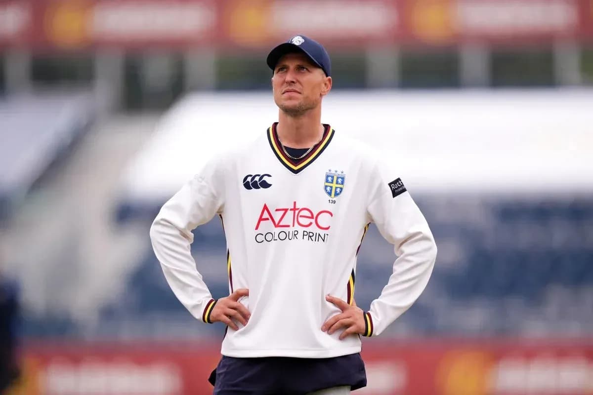 Cricketer wearing team jersey on field